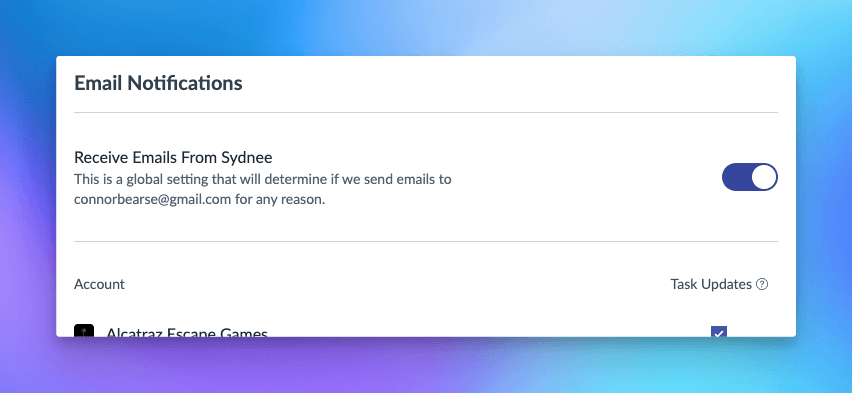 Screenshot of the Email Notifications settings in Sydnee showing a toggle option labeled ‘Receive Emails From Sydnee.’ This global setting determines whether emails are sent to connorbearse@gmail.com for any reason. The toggle is switched on. Below, individual account settings are listed, including ‘Alcatraz Escape Games,’ with an option to enable or disable ‘Task Updates’ notifications, which is currently checked.